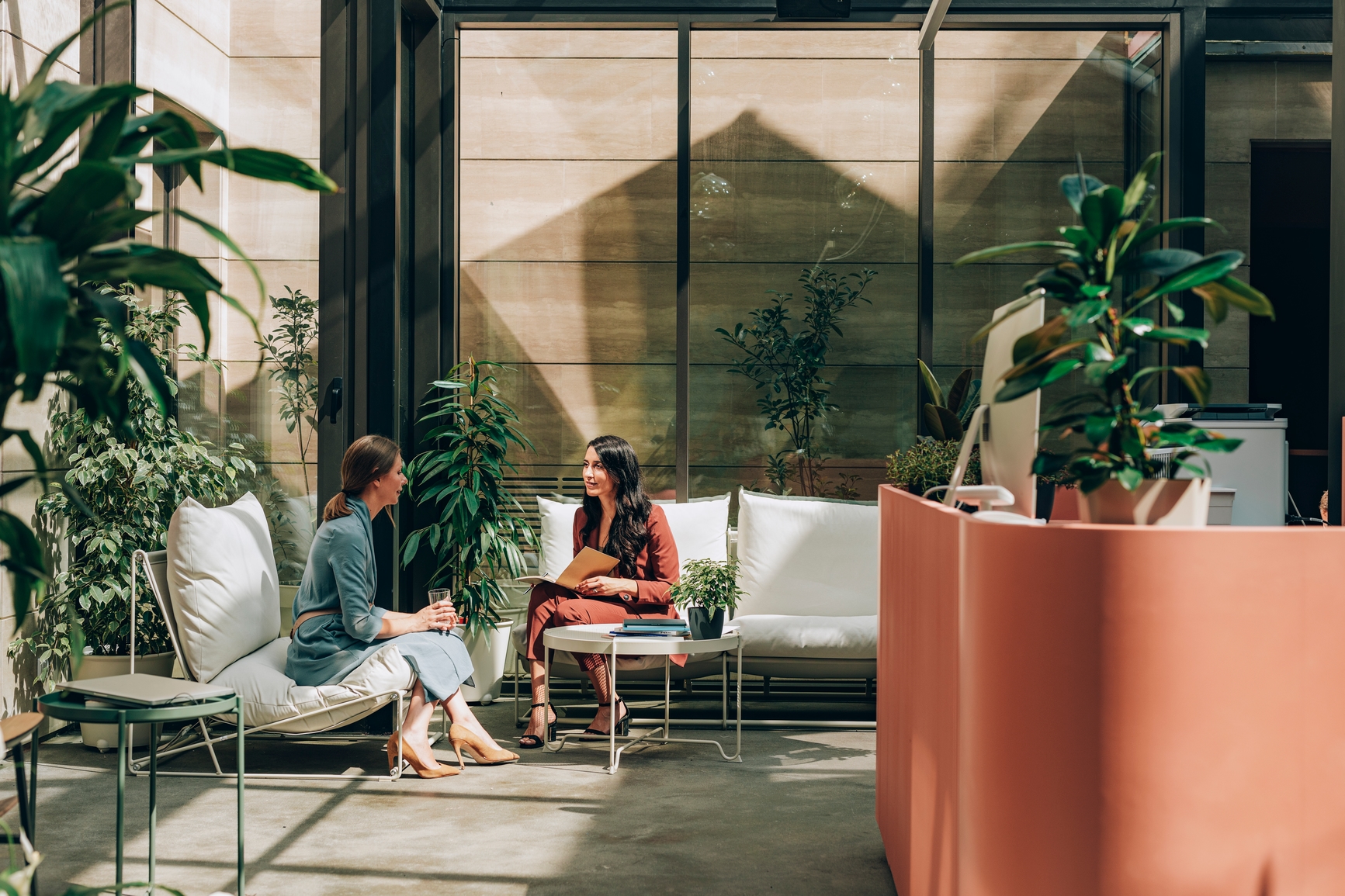 Two smart women in interview in reception area
