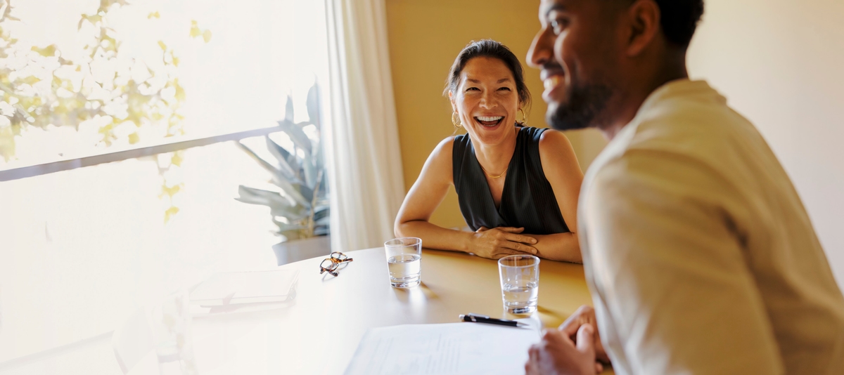 Woman and man at desk smiling